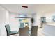 Modern dining room with glass table and view into kitchen at 25188 Marion Ave # D101, Punta Gorda, FL 33950