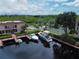 Aerial view of waterfront community with boat slips, pool, and tennis courts at 25188 Marion Ave # D101, Punta Gorda, FL 33950