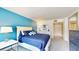 Bedroom with a blue accent wall and a comfortable queen bed at 25188 Marion Ave # D101, Punta Gorda, FL 33950