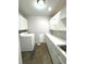 Bright laundry room with washer, dryer, and cabinets at 1185 Bayshore Dr, Englewood, FL 34223