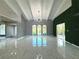 Open living area with high ceilings, marble floors, and green wall at 1185 Bayshore Dr, Englewood, FL 34223