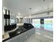 Open living area with a unique water feature, fireplace, and pool view at 1185 Bayshore Dr, Englewood, FL 34223