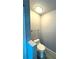 Small half bathroom with toilet and glass shelf at 1185 Bayshore Dr, Englewood, FL 34223