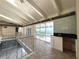 Wet bar with tile backsplash and sliding glass doors to balcony at 1185 Bayshore Dr, Englewood, FL 34223