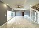 Open living area with gray walls, marble floors, and access to the pool at 1185 Bayshore Dr, Englewood, FL 34223