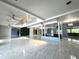 Bright living room featuring marble floors and a two-story high ceiling at 1185 Bayshore Dr, Englewood, FL 34223