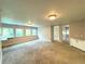 Spacious bonus room with multiple windows and carpet flooring at 1185 Bayshore Dr, Englewood, FL 34223