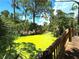 Wooden footbridge over a calm canal with lush vegetation at 1185 Bayshore Dr, Englewood, FL 34223