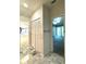 Bathroom with marble floors, linen closet, and access to bedroom at 1185 Bayshore Dr, Englewood, FL 34223
