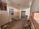 A fixer-upper kitchen with tiled floors and partial walls at 21098 Glendale Ave, Port Charlotte, FL 33952