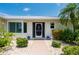 Front entrance with walkway, landscaping, and metal roof at 1425 Pine Island Ct, Punta Gorda, FL 33950