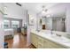 Double vanity bathroom with light green cabinets and a large mirror at 22333 Edgewater Dr # C4, Port Charlotte, FL 33980