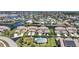 An aerial view shows the house on the water, surrounded by other homes, canals and a pool at 3800 Bal Harbor Blvd # 212, Punta Gorda, FL 33950