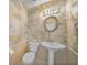 Charming powder room featuring unique map-themed wallpaper, a pedestal sink, and a classic toilet at 3800 Bal Harbor Blvd # 212, Punta Gorda, FL 33950
