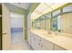 Bright bathroom featuring a spacious vanity with ample storage and a large mirror at 3800 Bal Harbor Blvd # 212, Punta Gorda, FL 33950