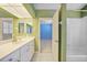 Bathroom with bright vanity, tile floor, and view into connecting bedroom and bathroom at 3800 Bal Harbor Blvd # 212, Punta Gorda, FL 33950