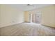 Comfortable bedroom with plush carpet, neutral walls, and sliding glass doors to the outdoor patio at 3800 Bal Harbor Blvd # 212, Punta Gorda, FL 33950