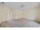 Large bedroom with plush carpeting, a ceiling fan, and easy access to the attached en-suite bathroom at 3800 Bal Harbor Blvd # 212, Punta Gorda, FL 33950