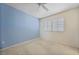Bedroom with one blue accent wall, carpeted flooring, and window with shutters at 3800 Bal Harbor Blvd # 212, Punta Gorda, FL 33950