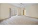 Spacious bedroom with plush carpeting and access to a private outdoor patio with brick pavers at 3800 Bal Harbor Blvd # 212, Punta Gorda, FL 33950