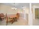 Dining room featuring tile flooring, decorative columns, and a stylish chandelier at 3800 Bal Harbor Blvd # 212, Punta Gorda, FL 33950