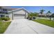 Exterior of house features a two car garage and mature landscaping at 3800 Bal Harbor Blvd # 212, Punta Gorda, FL 33950