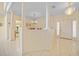 Spacious foyer with tiled floors, decorative columns, chandelier, and view into other rooms at 3800 Bal Harbor Blvd # 212, Punta Gorda, FL 33950
