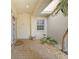 The front door is decorated with a security door, a potted plant, and rock landscaping at 3800 Bal Harbor Blvd # 212, Punta Gorda, FL 33950