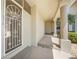 Inviting front entrance with decorative security door, tiled walkway, and lush tropical landscaping at 3800 Bal Harbor Blvd # 212, Punta Gorda, FL 33950