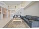Living room with soaring ceilings, stairs and tile floors at 3800 Bal Harbor Blvd # 212, Punta Gorda, FL 33950