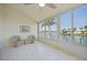 Bright sunroom showcasing expansive windows with serene views of the water and tiled floors at 3800 Bal Harbor Blvd # 212, Punta Gorda, FL 33950
