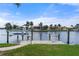 Private boat dock with lift, steps and grassy area at 3439 Nighthawk Ct, Punta Gorda, FL 33950