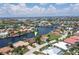 Aerial view of waterfront home with private dock and lush landscaping at 3439 Nighthawk Ct, Punta Gorda, FL 33950