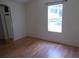 Bright bedroom with mirrored closet doors and window at 5787 Holiday Park Blvd, North Port, FL 34287