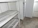 Unfinished basement with shelving and a refrigerator at 5787 Holiday Park Blvd, North Port, FL 34287