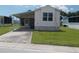Front view of a manufactured home with carport at 5787 Holiday Park Blvd, North Port, FL 34287