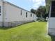 Single-wide manufactured home with a side yard at 5787 Holiday Park Blvd, North Port, FL 34287