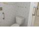 Clean bathroom with toilet and floral wallpaper at 5787 Holiday Park Blvd, North Port, FL 34287