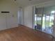 Living room with light flooring and sliding glass doors to backyard at 5787 Holiday Park Blvd, North Port, FL 34287