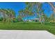 Spacious backyard with lush grass and mature palm trees at 4582 Enid Ln, North Port, FL 34288
