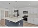 Modern kitchen with white cabinets and center island at 4582 Enid Ln, North Port, FL 34288