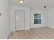 Bright and airy entryway with light wood flooring and a white door at 4582 Enid Ln, North Port, FL 34288