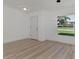 Bright dining room with large window and wood floors at 4582 Enid Ln, North Port, FL 34288