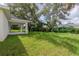 Spacious backyard with covered patio and lush green grass at 1019 Cazenovia St, Port Charlotte, FL 33952
