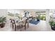 A beautifully staged dining area with a modern table, seating for six, and views into the cozy living room at 16429 Bridle Ridge St, Port Charlotte, FL 33953