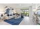 A spacious living room featuring a plush sofa, stylish decor, and sliding glass doors to the outdoor area at 16429 Bridle Ridge St, Port Charlotte, FL 33953