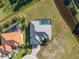 Aerial view of gray roof home with a pool, waterfront, and manicured lawn at 24051 Pyramid Way, Punta Gorda, FL 33955