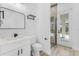 Well-lit bathroom with a modern sink, a tiled walk-in shower, and access to the outdoor screened lanai at 24051 Pyramid Way, Punta Gorda, FL 33955