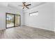 Bright, spacious bedroom featuring tray ceilings, wood floors, and a seamless transition to the screened lanai at 24051 Pyramid Way, Punta Gorda, FL 33955
