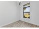 Bright bedroom with light wood floors and a window with a scenic view of the outdoors at 24051 Pyramid Way, Punta Gorda, FL 33955